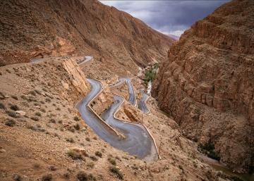 Hairpins by Linda Wride - Hairpin bends zig zag out of the Dades Gorge
